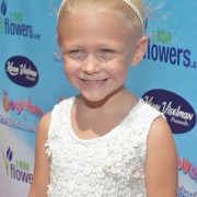 Alvia Alyn Lind at Oogieloves Premiere in front of TRIO printed step & repeat
