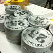 TRIO CNC-routed, printed graphics on 'Coin' props - 'Big Brother' Laundramat Challenge