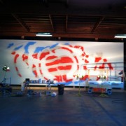 TRIO hand-painting the backdrop for Rise Against