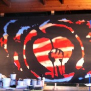 TRIO hand-painting the backdrop for Rise Against