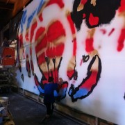TRIO hand-painting the backdrop for Rise Against
