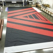 Printing the Invisible Children backdrop in TRIO's shop