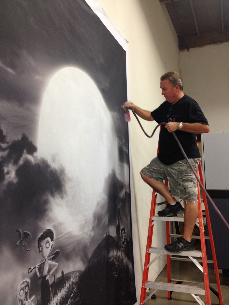 TRIO owner, Ed Strang, airbrush painting Frankenweenie backdrop