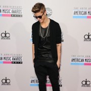 Justin Bieber in front of TRIO printed step and repeat - 40th Annual AMAs